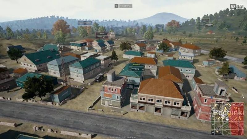 "Bird's-eye view of Pochinki, a high-action urban hotspot in PUBG Mobile's Erangel map, featuring tightly packed houses with colorful roofs, wide streets, and surrounding open fields and hills, ideal for both loot and intense combat scenarios."